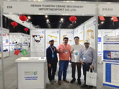 Yuantai Cranes engineers introducing rubber tyred gantry crane (RTG) solutions to customers at the 2025 Saudi Arabia Industrial Machinery Exhibition.